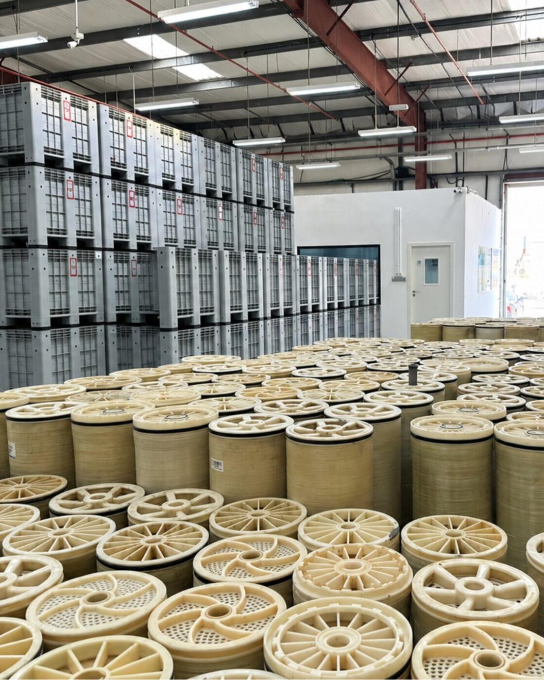 The Second Life RO plant floor, hundreds of membrane elements standing end up with intake crates stacked behind